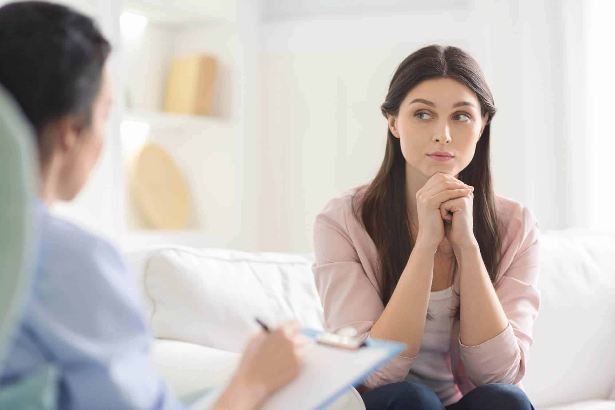 interested young woman listening carefully to psychiatrist