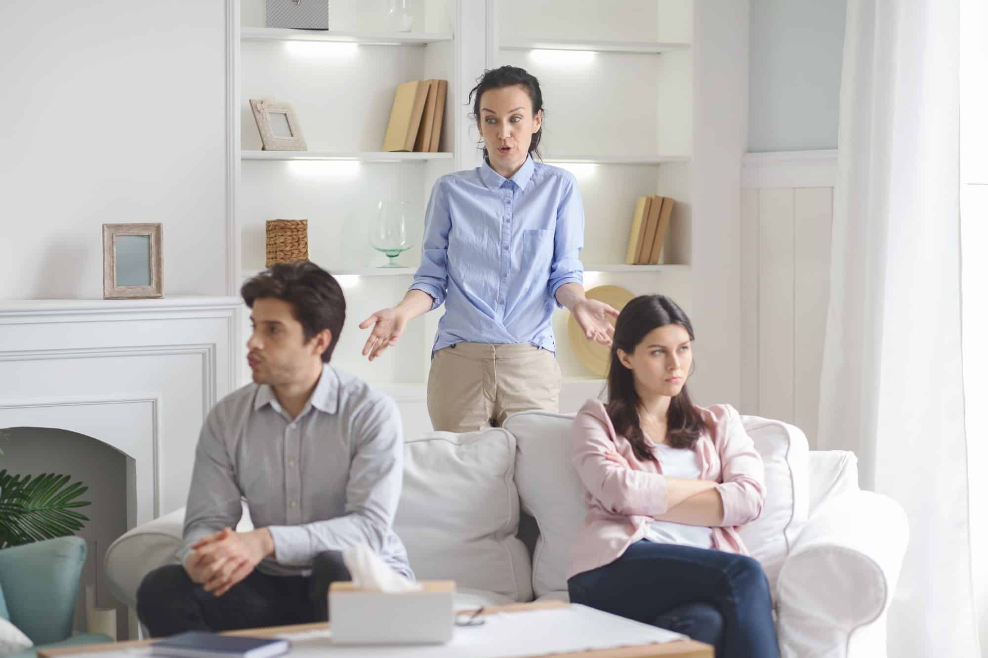 professional therapist working with fighting young couple