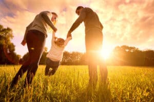 Parents hold the baby's hands